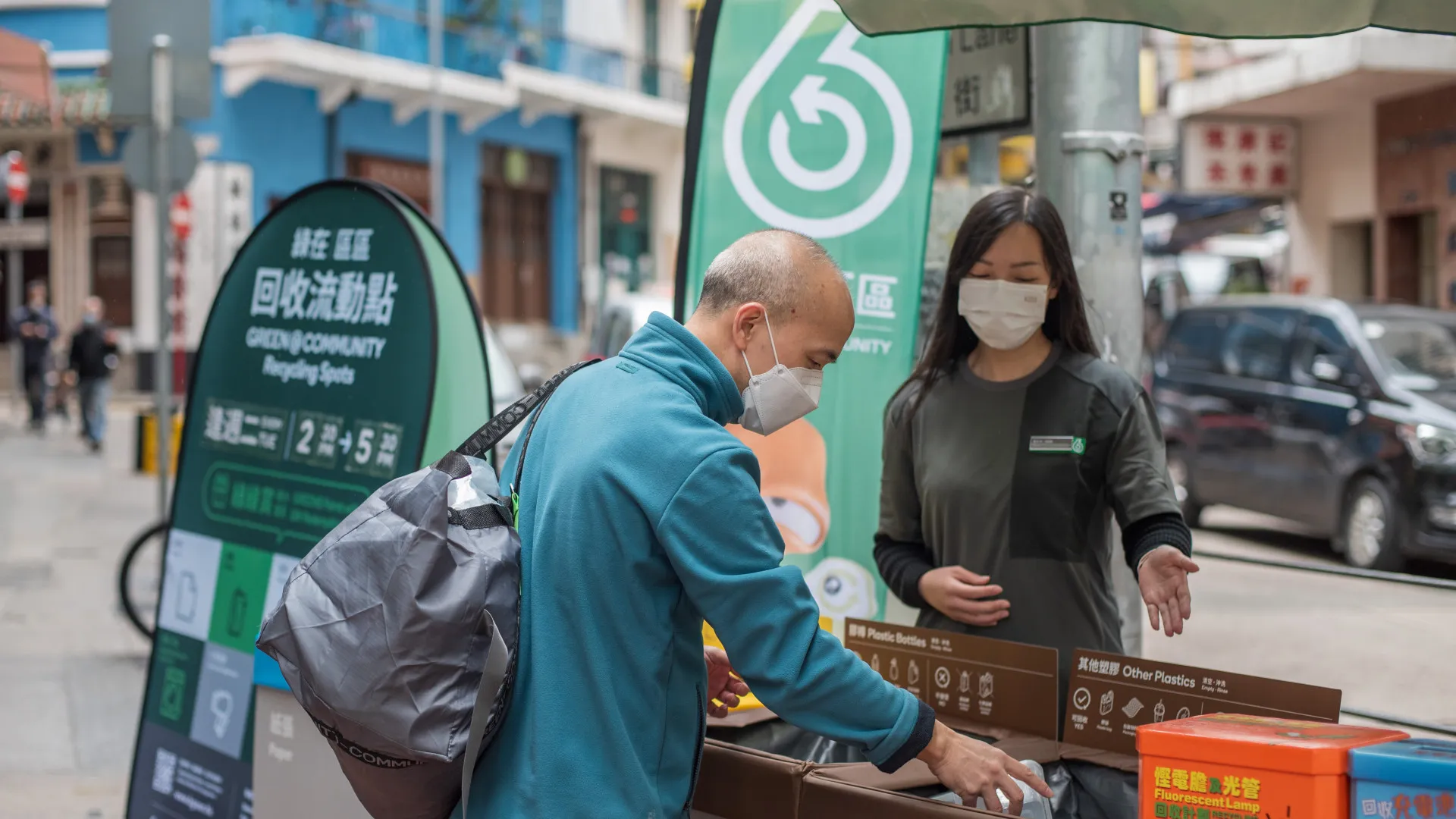 Public participating in recycling with assistance from staff at Recycling Spot